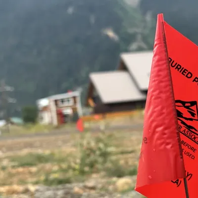 A flag marking a buried electric utility line.